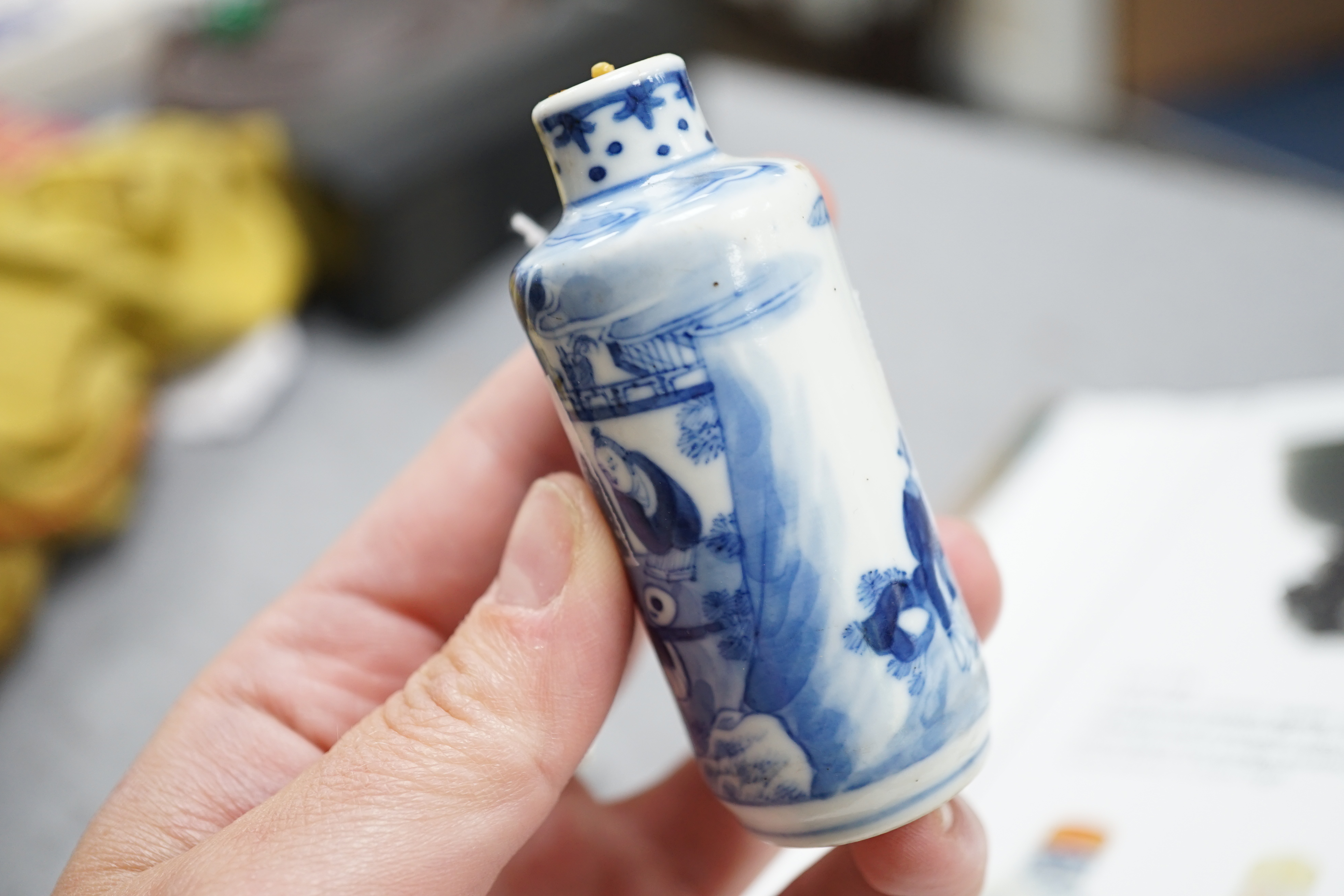 A Chinese iron red enamelled ‘dragon’ snuff bottle, Tongzhi mark and of the period (1862-74), together with two Chinese blue and white cylindrical snuff bottles, 19th century
